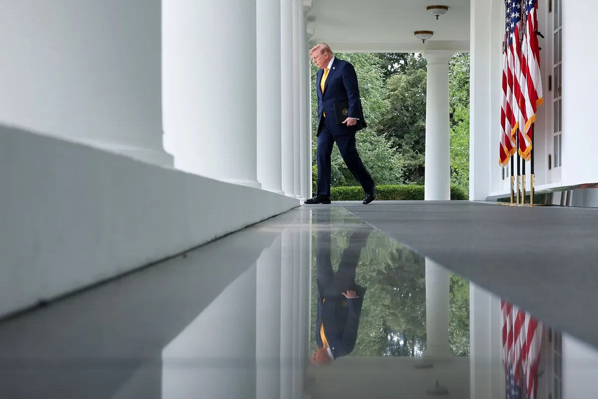 President Donald Trump walks from the Oval Office to the Rose Garden of the White House on August 24.